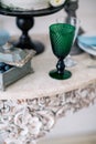 Beautiful decorate table with glass, candles, vase with flowers and wedding cake on the table in studio Royalty Free Stock Photo