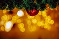 Beautiful decorated Christmas tree background with bauble and xmas ornaments blurred in gold bokeh. Royalty Free Stock Photo