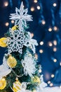 Beautiful decorated christmas tree with snow on the blurred bokeh of the garland. Holiday background Royalty Free Stock Photo