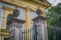 Beautiful decorated church fence with stone pillars with jars on them