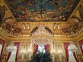 Beautiful decorated Napoleon apartments at Louvre palace. Royal family rooms with cardinal red curtains, golden ornate walls,