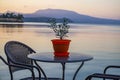 Beautiful decorated table with a colorful flower pot by the sea coast at Koroni in Messenia, Greece