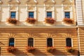 A beautiful decorated yellow beige house with arch-form windows