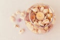 Seashells, vase and candle on a white table sheet.