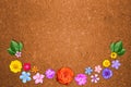 Beautiful decoration flowers frame with empty in center on orange hardboard background. Floral composition of spring or summer flo