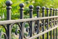 Beautiful decorative cast metal wrought fence with artistic forging. Iron guardrail close up.