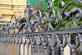 Beautiful decorative cast metal wrought fence with artistic forging. Iron guardrail closeup.