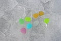 Decorative colored stones on snow and ice. round shape colorful elements Royalty Free Stock Photo