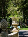 A beautiful decorative flowerpot with flowers and grass, set in a park, on a sunny summer day Royalty Free Stock Photo