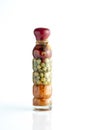 Green peas, carrots and tomatoes in decorative glass bottle for aesthetic beauty