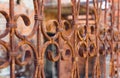Beautiful decorative metal fence with artistic forging after a fire. Rusty iron guardrail close up.