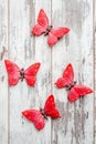 Beautiful Decorative Red butterflies on White Wooden Background Royalty Free Stock Photo