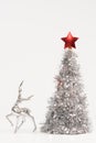 Beautiful deer figurine and lush Christmas tree