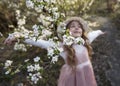 Beautiful defocused little girl enjoy in nature, The spring flowers in the foreground