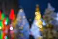 Beautiful defocused white christmas trees and happy new year celebration event light in yellow, green, red and gold color bokeh