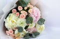 Beautiful delicate bouquet of mixed flowers on a light background. Flower background. Flower shop concept, flower delivery. Close- Royalty Free Stock Photo