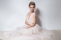 Beautiful delicate bride girl in soft pink skazachno wedding dress with a cut on the chest and back with makeup and evening h