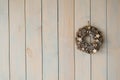 Beautiful delicate Christmas wreath on the gray wall. Copy space