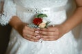 Beautiful delicate flower wedding bouquet and with white and red flowers in the bride`s hands in a lace dress Royalty Free Stock Photo