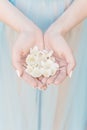 Beautiful delicate hands of a girl with jasmine flowers in their hands, Fine art style