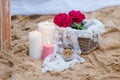 Beautiful, delicate wedding decorations with candles and fresh flowers on the beach Royalty Free Stock Photo