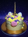 A beautiful cake in the shape of a unicorn decorated with delicate cream.