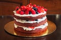 Beautiful delicious red velvet cake with strawberries and blueberries on the table Royalty Free Stock Photo