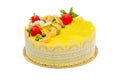 Beautiful delicious yellow cake with fruit and caramel decorations with a smooth jelly surface isolated on a white background