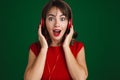 Beautiful delighted brunette girl listening music with headphones