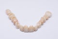 Beautiful dental bridge isolated on wite made of ceramic porcelain. Aesthetic restoration of tooth loss. Ceramic