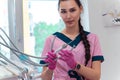 Beautiful dentis in pink uniform looking at the camera Royalty Free Stock Photo