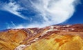 Beautiful desert landscape, barren dry colorful mountains, blue summer sky, fluffy cloud - Coridillera de Copiapo, Atacama, Chile