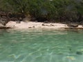 A beautiful deserted beach behind a transparent sea Royalty Free Stock Photo