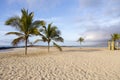 Beautiful deserted beach with coconut trees and wooden lookout platforms seen in the early morning