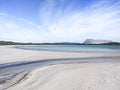 Beautiful deserted white beach in Sardinia, Lu Impostu, with sea in various shades of blue, curves of sand marked by water and the Royalty Free Stock Photo