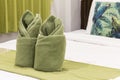 Green towels on bed