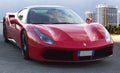 Beautiful design of luxury model sports red supercar Ferrari 488 GTB in a beautiful sunny day