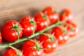Bunch of red cherry tomatoes on a wood cutting board Royalty Free Stock Photo
