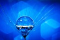 Beautiful dew drops on a dandelion seed. Macro. Beautiful soft light blue and violet background. Selective focus Royalty Free Stock Photo