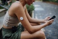 Beautiful diabetic woman preparing for outdoor workout in the city.