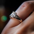 A beautiful diamond wedding ring in a woman finger.