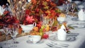 Beautiful dining table decorated with little autumn maple leaves