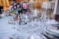 Beautiful dining table full of a variety of delicious festive food and wine with a Christmas tree in the background in warm mood