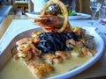 Beautiful dinner plate with impressive king prawns and seaweed noodles . Seafood , fish and delicious mustard sauce . Gourmet