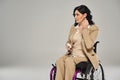 beautiful disabled woman in pastel suit