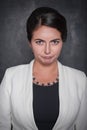 Beautiful discontent woman on blackboard background