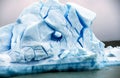 A beautiful disintegrating and melting iceberg with of blue ice and a hole inside