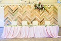 Beautiful display wall for a wedding featuring a chevron pattern made with reclaimed wood as a wonderful photo backdrop. Royalty Free Stock Photo