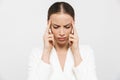 Beautiful displeased sad woman with headache posing isolated over white wall background Royalty Free Stock Photo