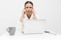 Beautiful displeased woman posing isolated over white wall background using laptop computer Royalty Free Stock Photo